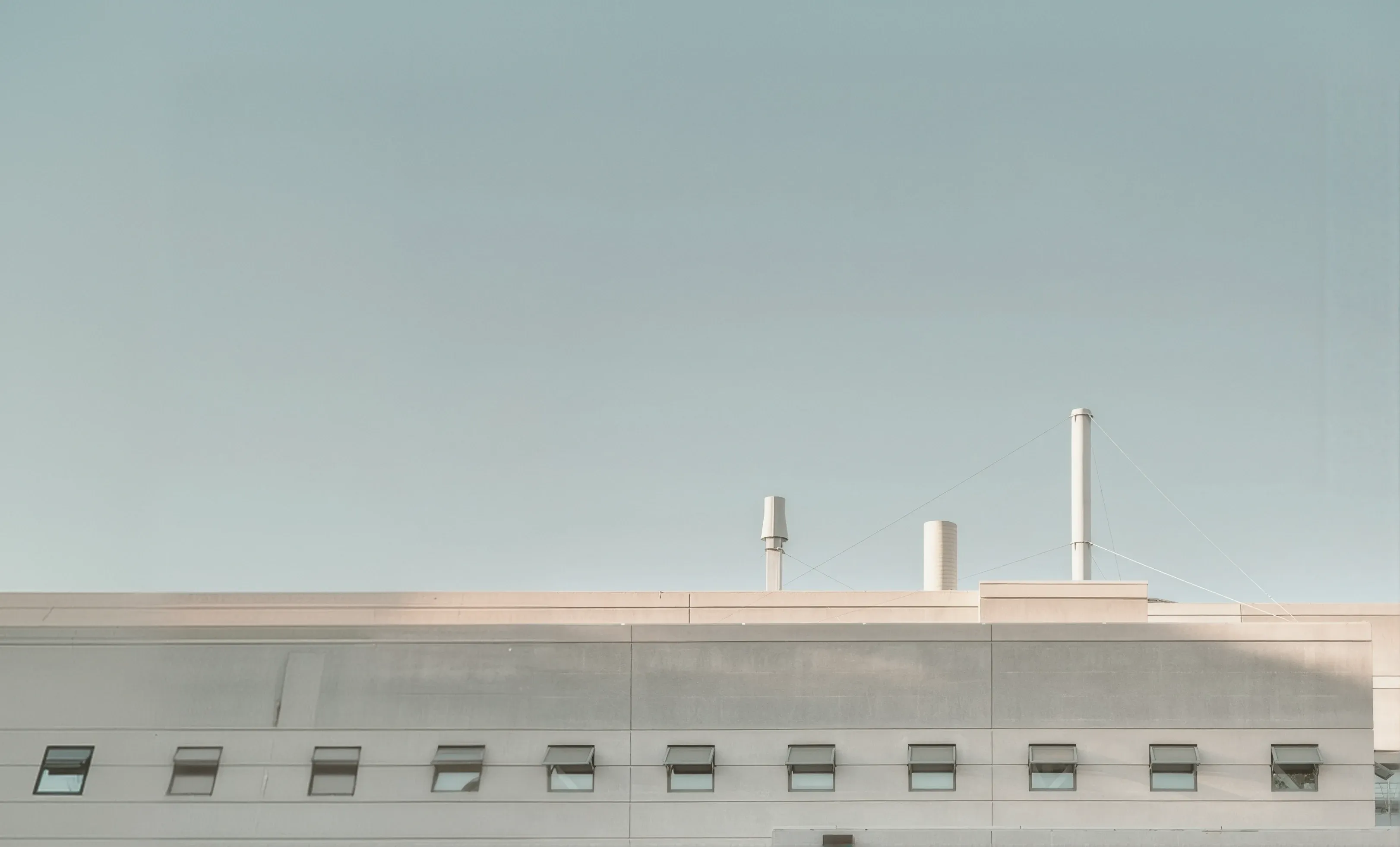 Factory rooftop with cooling towers under a clear sky