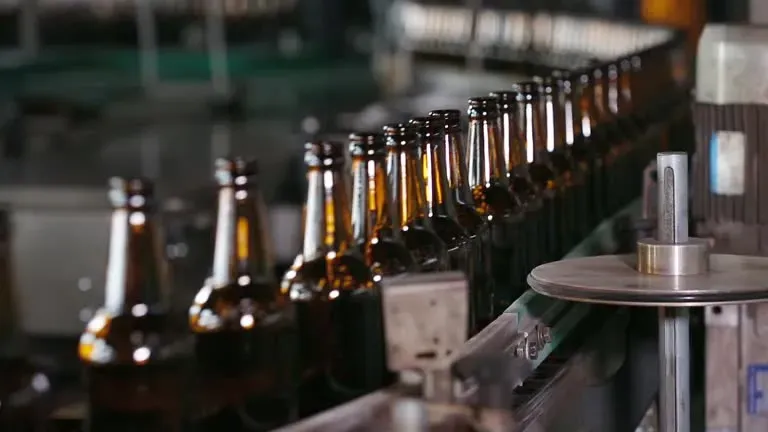 Brown glass bottles on a filling line